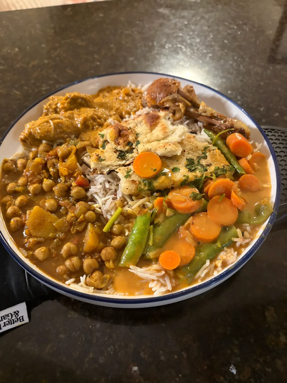 A homemade plate of rice, vegetables, chickpeas and flatbread